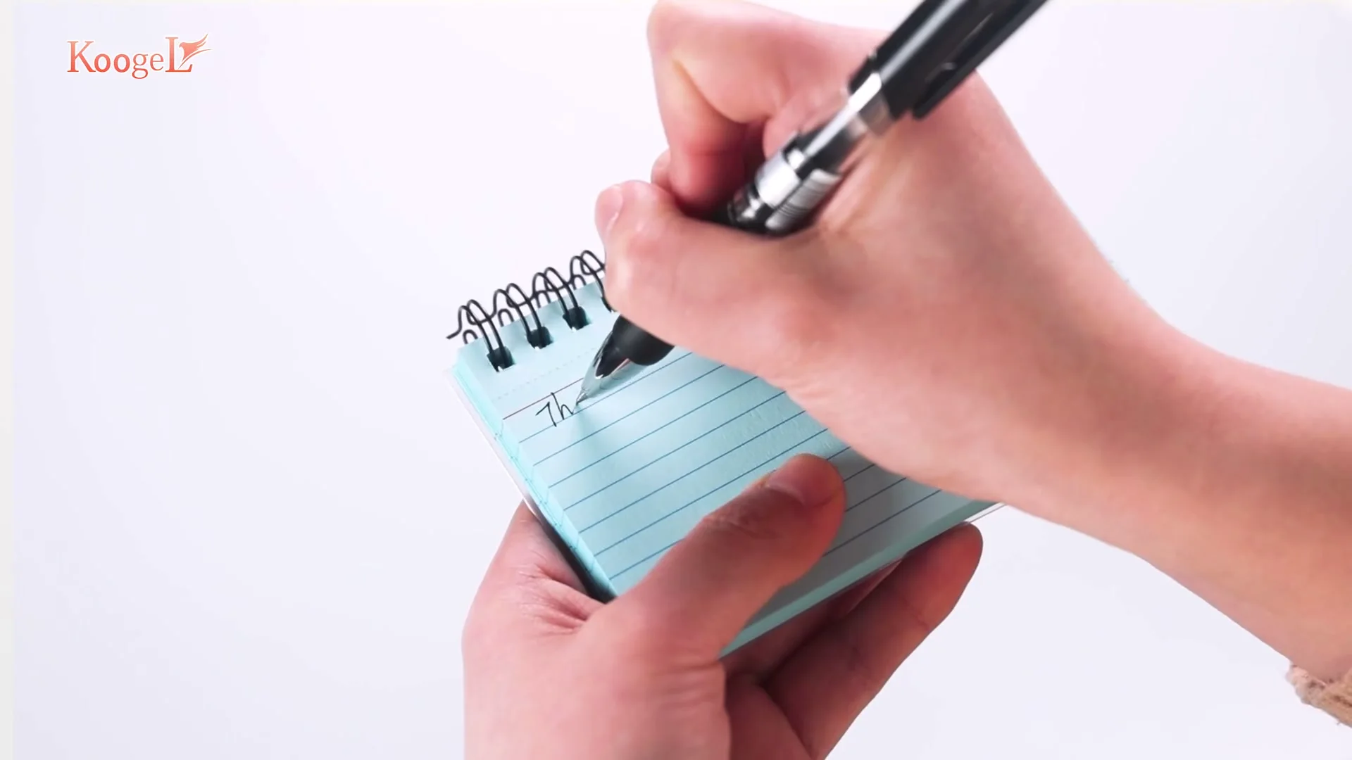 A hand writes study notes on a spiral-bound index card.