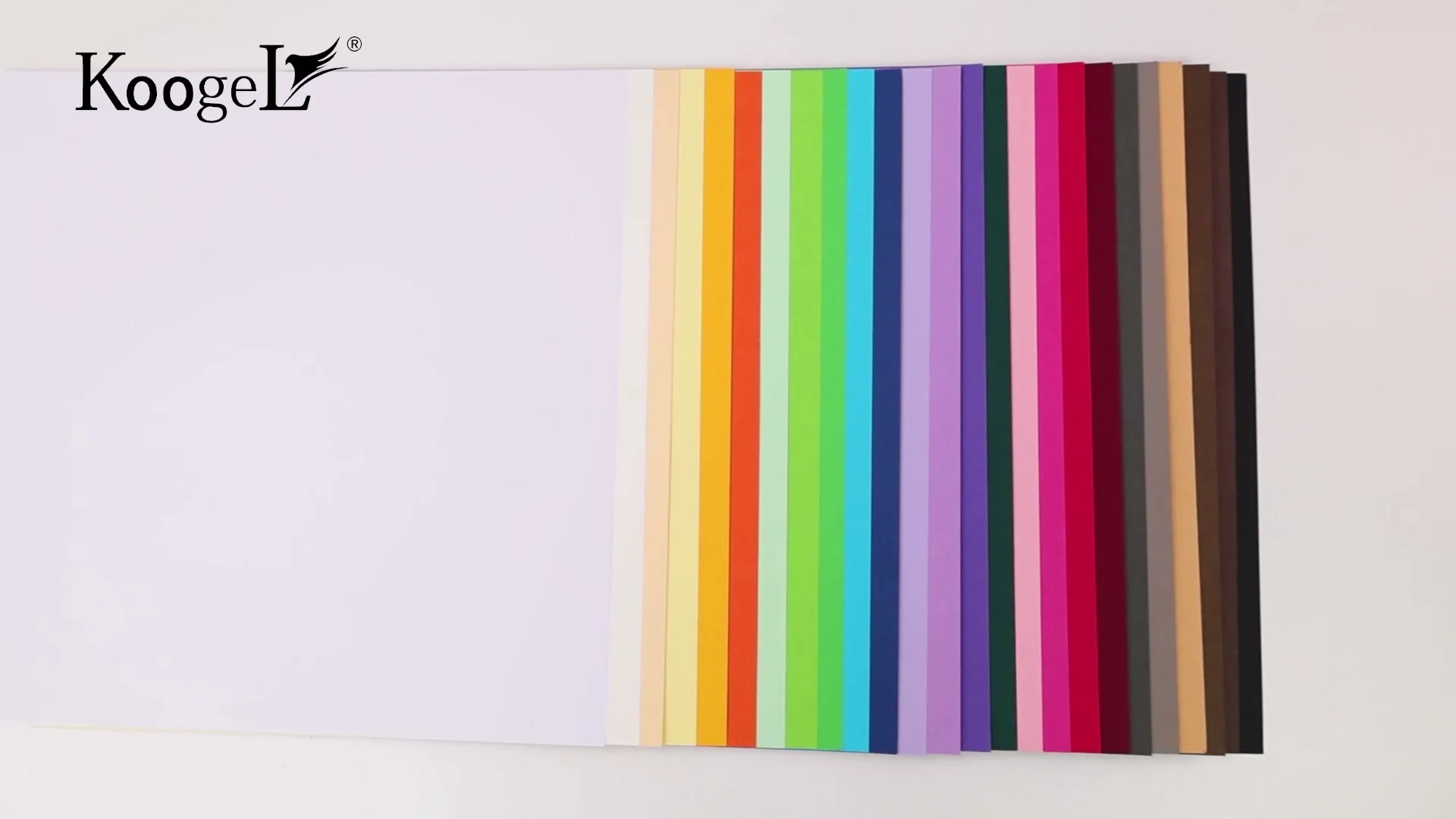 Sheets of Koogel colored cardstock spread on a table